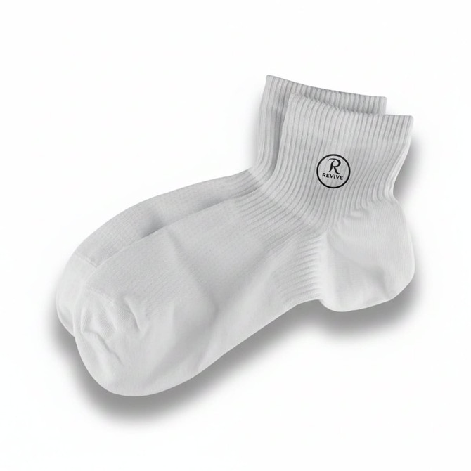 A pair of white socks with a branded logo on one side, featuring a ribbed design.