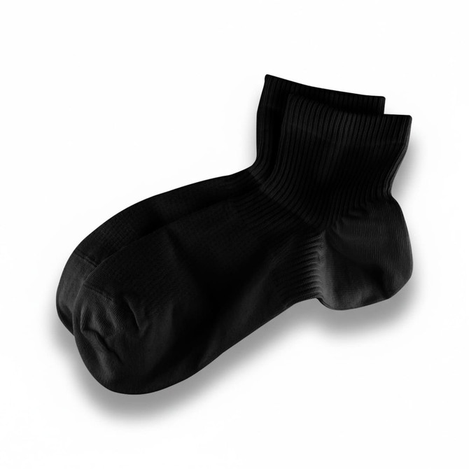 Black socks displayed with a ribbed texture. The socks are ankle-length and feature a branded logo.