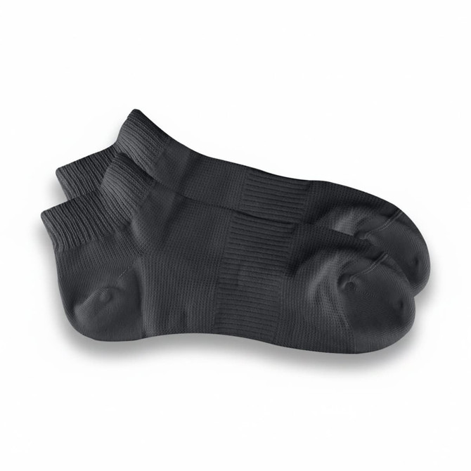 A pair of black ankle grip socks with ribbed texture and a snug fit, featuring a logo.