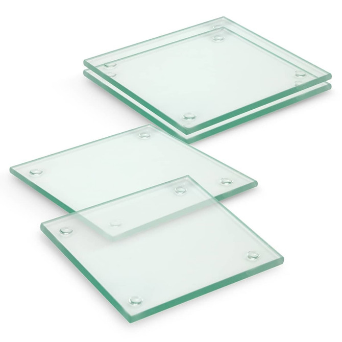 A set of four square glass coasters with a clear finish, featuring rounded edges and rubber grips at the corners.