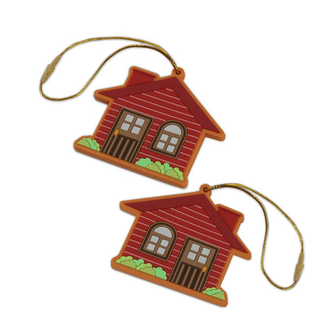Two red house-shaped PVC decorations with brown doors and green bushes, featuring a gold string for hanging.