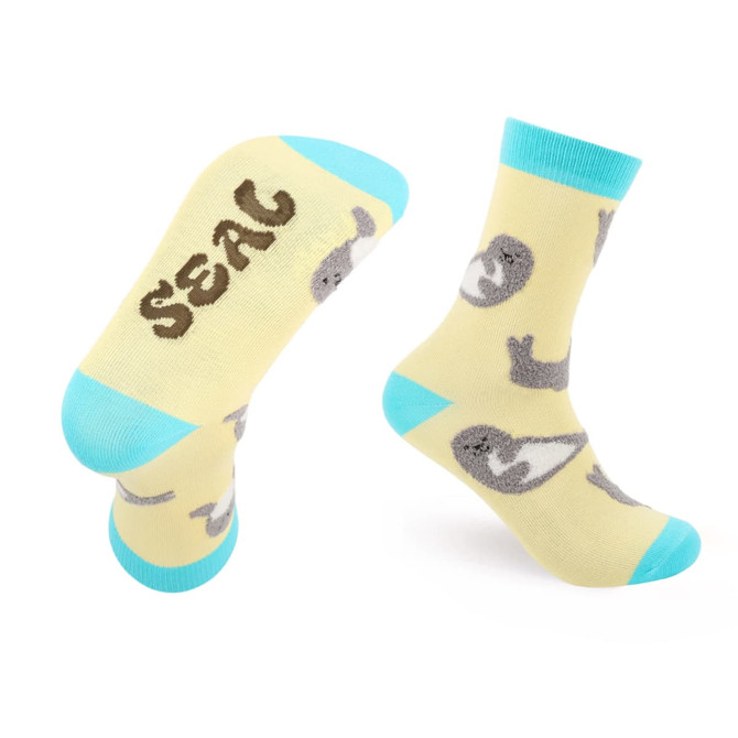 Woven socks in yellow featuring grey seals and turquoise accents, designed with a playful pattern.