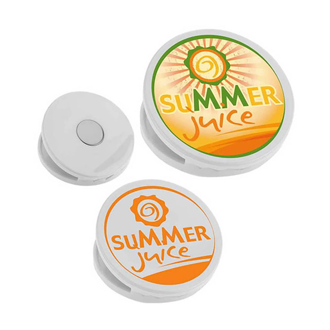 A round fridge magnet clip in white with vibrant summer juice designs in orange and yellow.