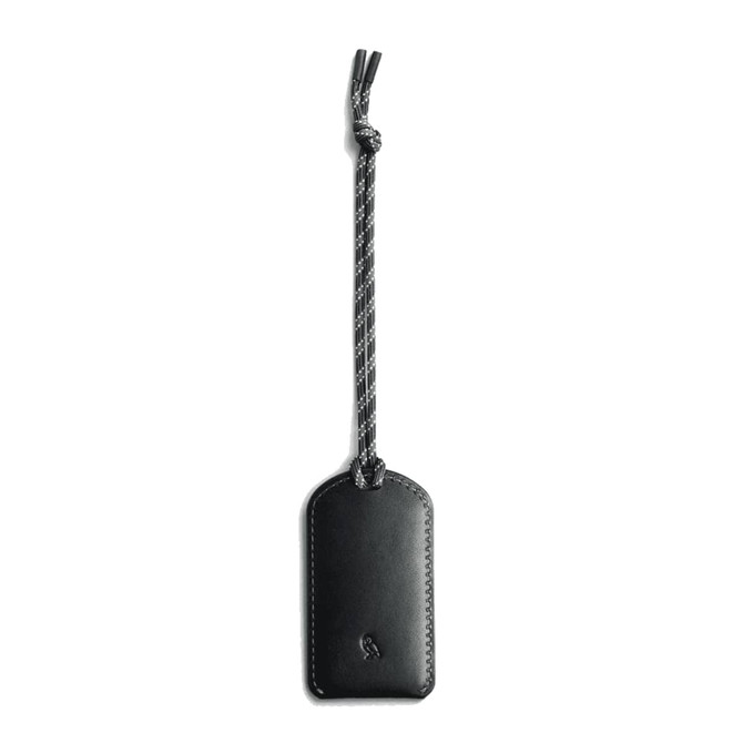 A black luggage tag made of leather, featuring a braided attachment. It has a logo on its surface.