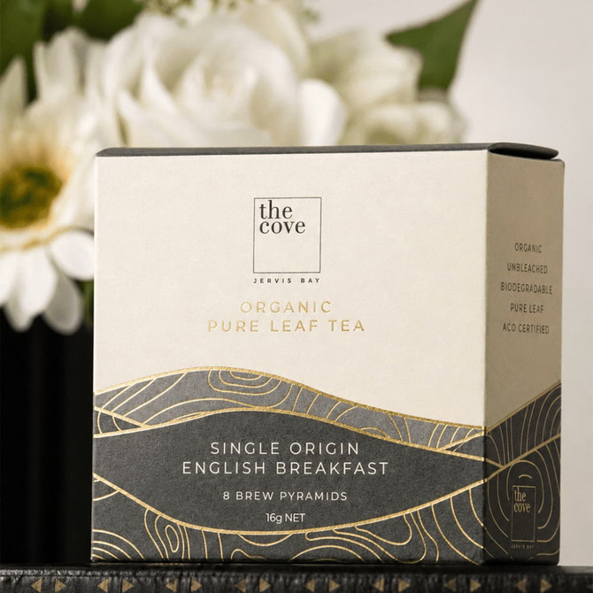 A box of organic pure leaf tea with a white and gold design, containing eight brew pyramids. It has a logo on the front.