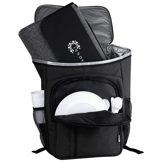 A grey picnic backpack with a thermal compartment, containing a blanket, plates, cutlery, and drink bottles.