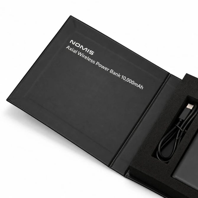 A black wireless power bank with a USB cable, displayed in a sleek box, featuring branding.