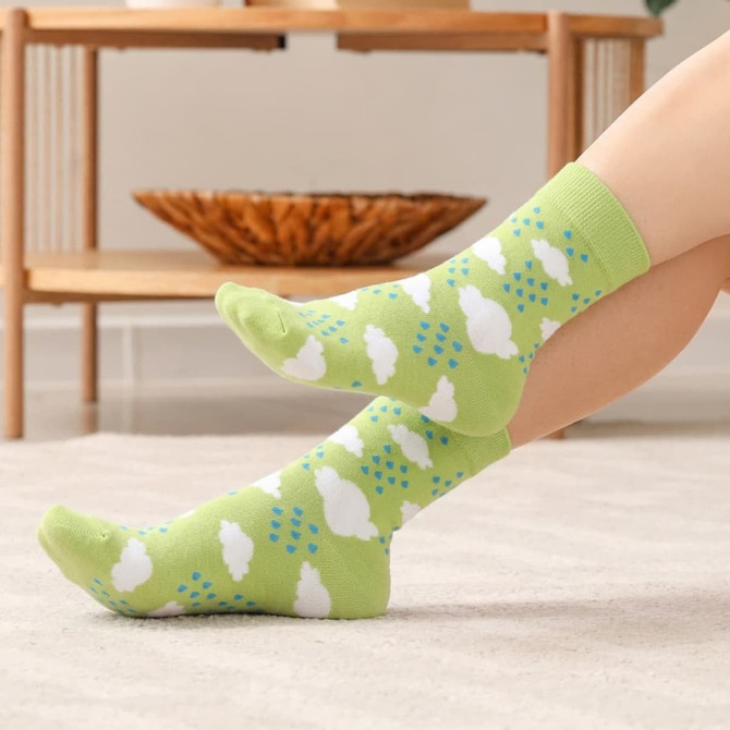 Bright green knitted socks featuring a cloud and rain pattern, set against a light background.
