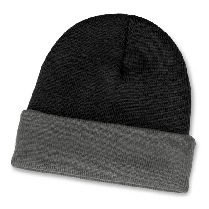 A two-toned beanie featuring black and grey hues with a folded cuff. It has a logo on the design.