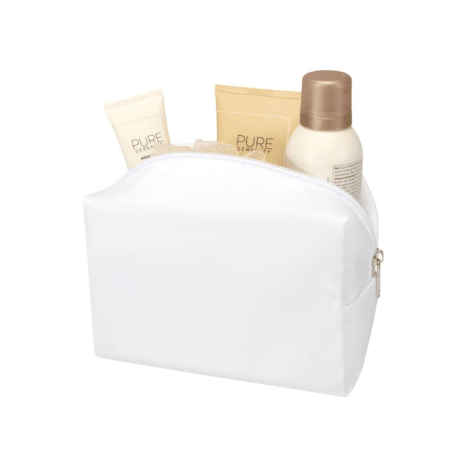 A white toiletry bag containing three cosmetic products in tubes and a bottle, all with neutral tones.