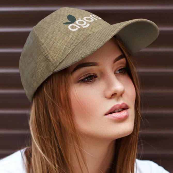 A cap in khaki with a branded logo, featuring a curved peak and textured fabric, worn by a model.