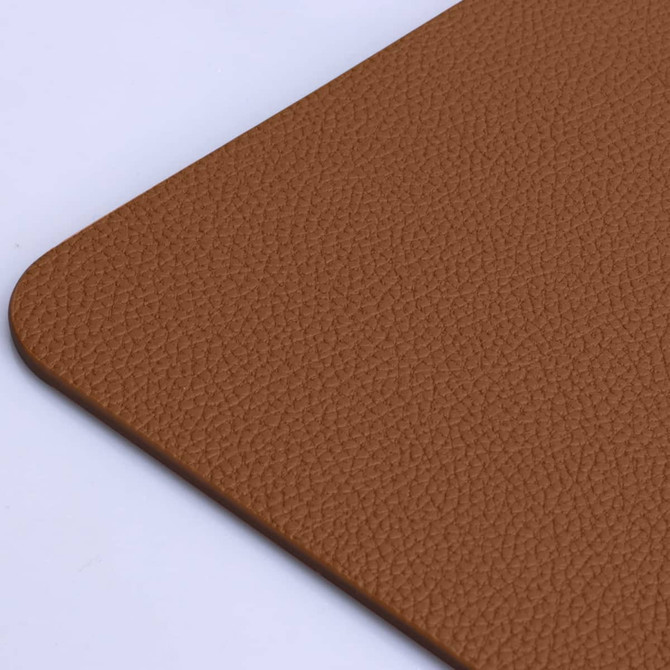A leatherette mouse mat in a warm brown tone with a textured surface and rounded edges, featuring a logo.