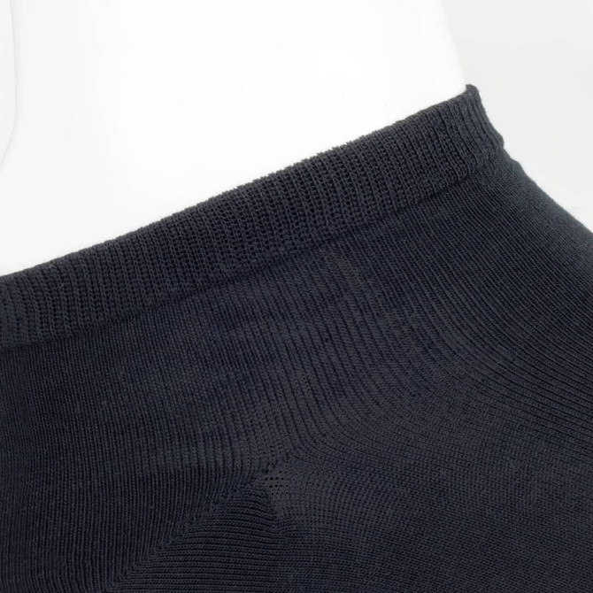 A pair of black ankle socks displayed on a mannequin, featuring a simple design and fitted cuff.