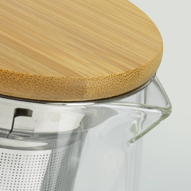 A teapot featuring a clear glass body, stainless steel infuser, and a bamboo lid.