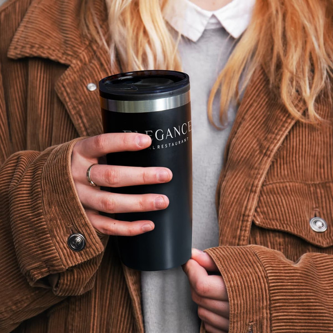 A double wall cup in black with a stainless steel lid, held by a person wearing a corduroy jacket.