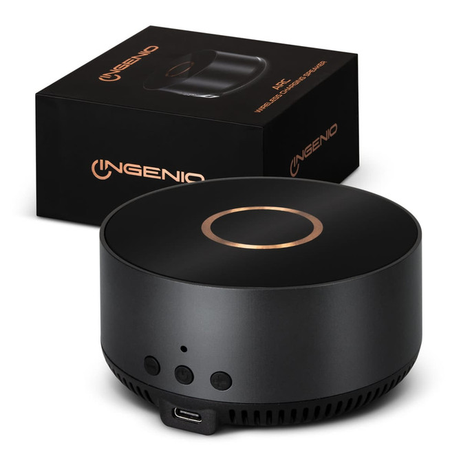 A wireless charging speaker in black with a sleek design, accompanied by its packaging featuring a logo.