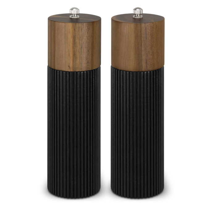 A pair of salt and pepper grinders with wooden tops and ribbed black bases. Each grinder has a silver knob on top.