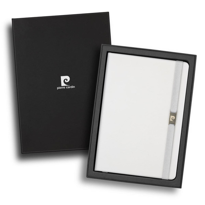 A white notebook in a black gift box, featuring a branding logo and a closure strap.