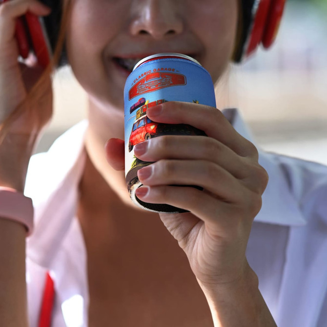 A drink bottle held by a person wearing headphones, featuring a blue design and a logo.