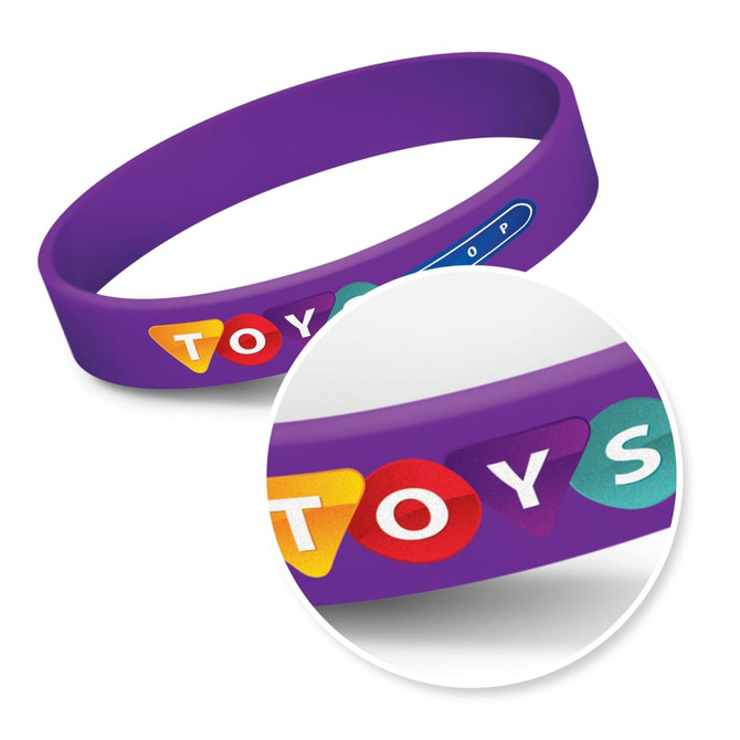 A purple silicone wristband featuring colourful circular designs and a branding logo.