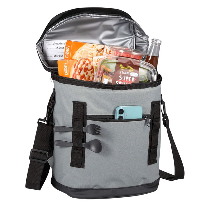 A grey cooler bag with multiple straps, containing food containers, a drink, and utensils inside.