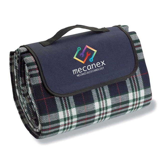 A folded picnic rug in dark blue and green plaid, featuring a handle and a logo.