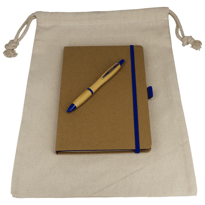 A drawstring bag in cream holds a brown JournalBook with a blue elastic band and a blue pen on top.