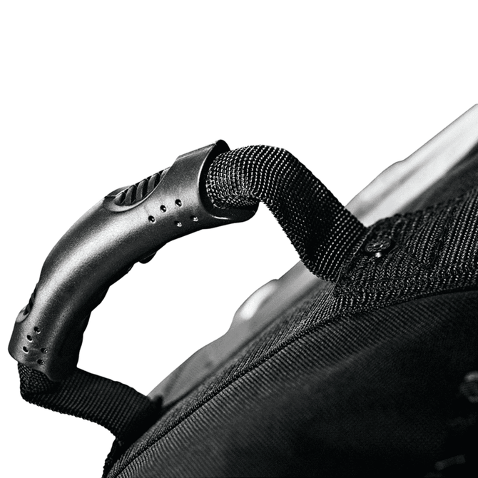 A close-up of a black wheeled duffel bag handle featuring a textured grip and attachment details.
