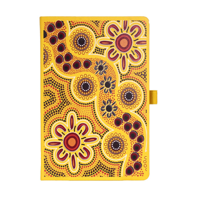 A yellow patterned journal with Aboriginal-inspired designs, featuring vibrant flowers and circular motifs, with a logo.