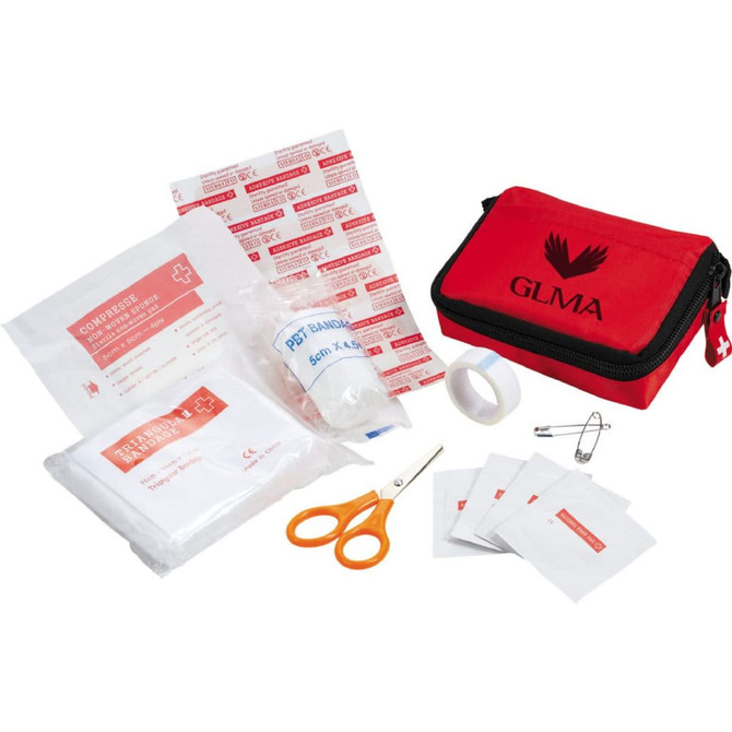 A red first aid kit containing bandages, compresses, scissors, tape, and antiseptic wipes, all neatly organised inside the pouch.