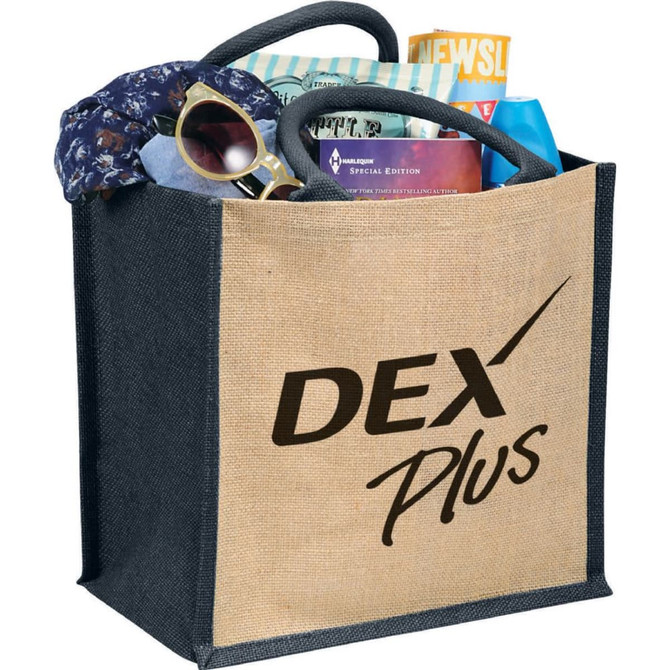 A jute tote bag with a black base, filled with a scarf, sunglasses, and various items, featuring a logo.
