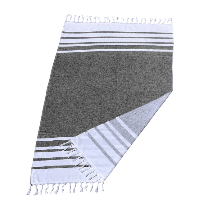 A grey and white striped Turkish beach towel featuring tasselled edges and soft fabric, ideal for beach use.