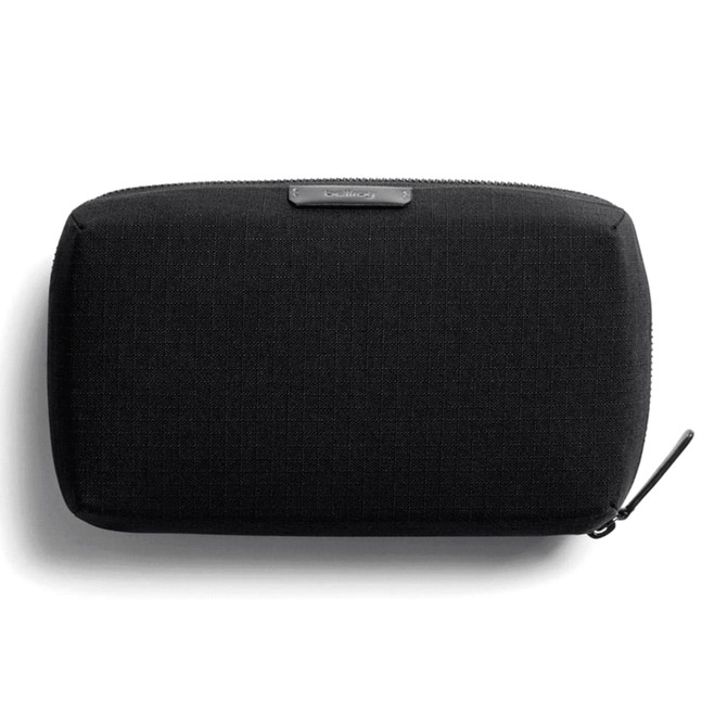 A black tech kit bag with a textured surface and a zip closure, featuring a branding logo.