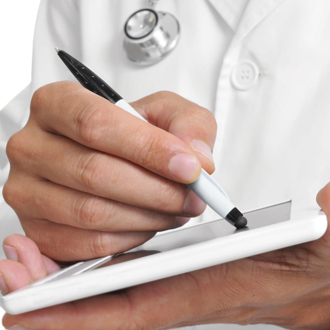 A stylus pen with a white barrel is being used to write on a tablet.