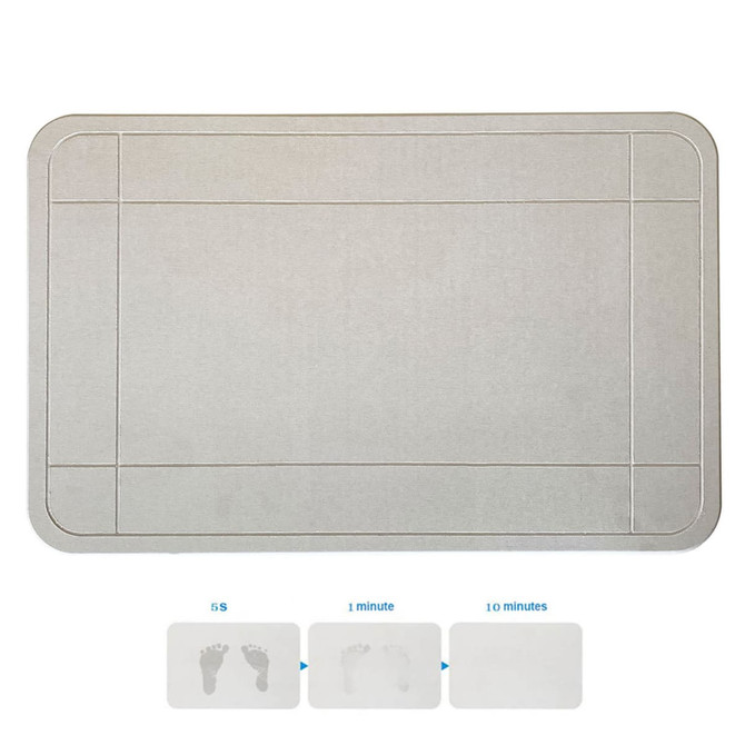 A grey bath mat with a textured surface, featuring a logo. It has bordered sections and shows footprints.