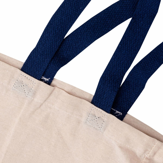 A beige tote bag with navy blue straps, featuring a logo on the fabric.