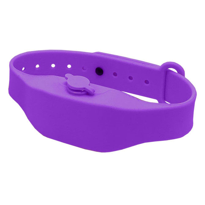 A purple wristband hand sanitiser dispenser with a button mechanism and adjustable strap. It features a logo.
