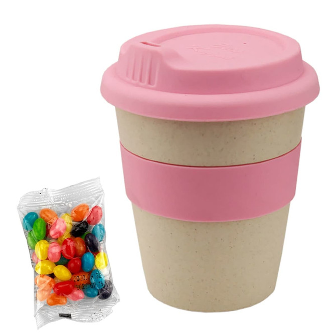 A bamboo cup with a pink lid and band, accompanied by a bag of colourful jelly beans.