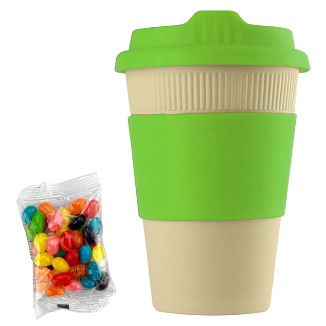 A reusable coffee cup in beige with a green silicone lid and sleeve, alongside a bag of colourful jelly beans.