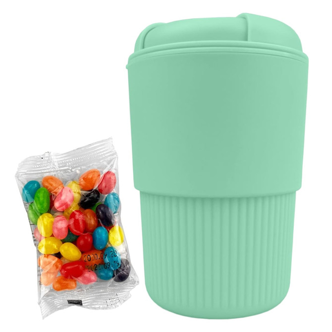 A reusable mint green coffee cup with ribbed texture, accompanied by a pack of colourful jelly beans.