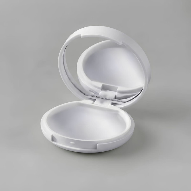 A white compact with a mirror, designed for lip gloss or lip balm. The interior is smoothly finished.
