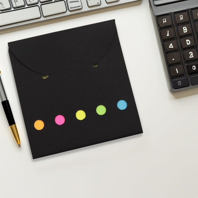 A black sticky note pad with colourful dots in pink, orange, yellow, green, and blue. Includes a logo.