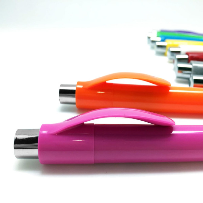 A set of plastic pens in various colours, featuring an orange and pink pen in the foreground. Each pen has a clip and silver accents.
