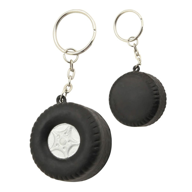 A black tyre-shaped stress keyring with a silver centre. Includes a metal keyring attachment and a branding logo.