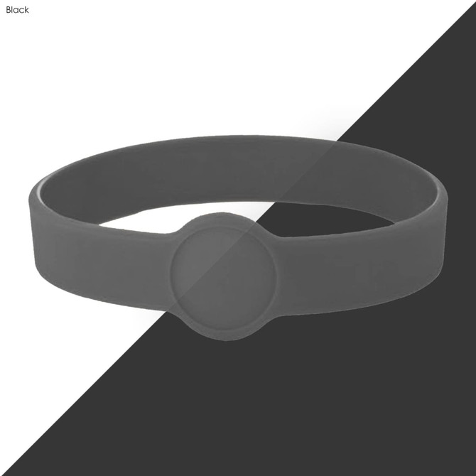 A black silicone wristband with a smooth circular design, featuring a logo or branding on the surface.