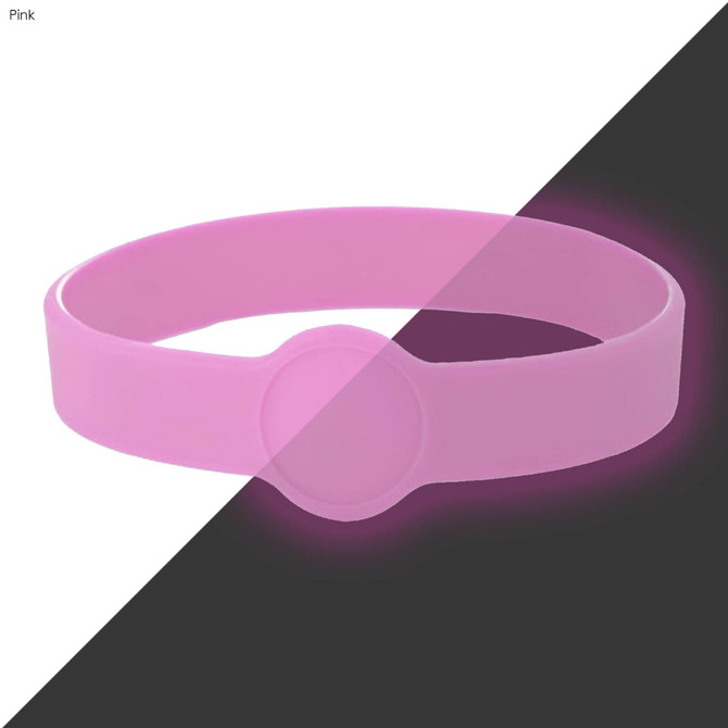 A pink silicone wristband with a round feature, suitable for custom designs. It has a simple, smooth finish.