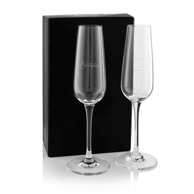 A twin pack of elegant glass flutes, clear glass with tall stems, presented in a black gift box.