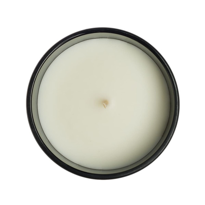 A medium Gleam Glass Candle featuring a smooth, white wax surface with a centered wick, contained in a sleek black jar.