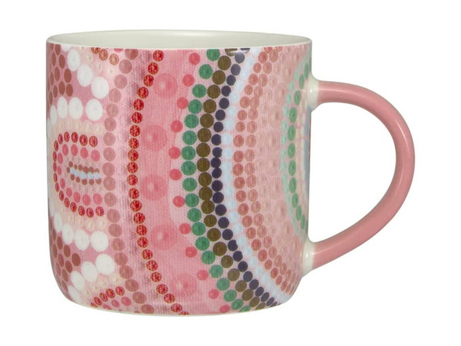 A drink mug in pink tones featuring a vibrant dotted pattern, with a solid pink handle. It has a logo.
