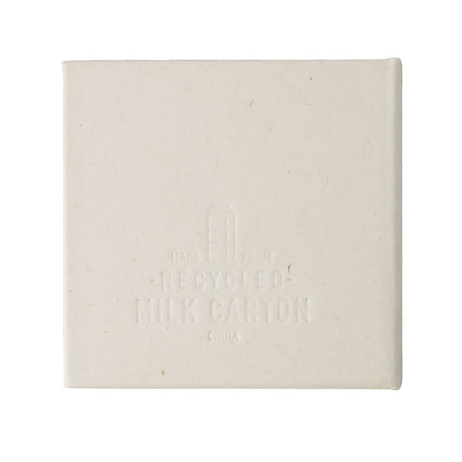 A square note block made from recycled materials, featuring a light cream colour and a subtle texture. It has a logo.